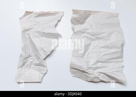 Crumpled old checkered paper on isolated white background, old textured sheets with torn edges and copy space for text Stock Photo