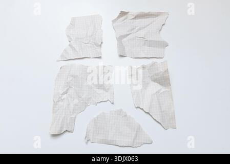 Crumpled old checkered paper on isolated white background, old textured sheets with torn edges and copy space for text Stock Photo