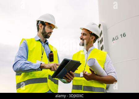 Engineers discussing wind turbine project plan Stock Photo
