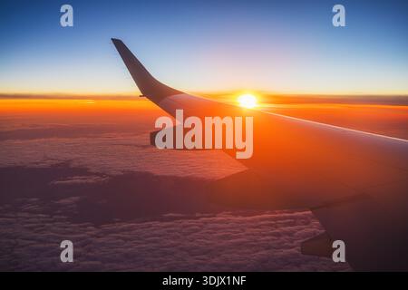 Aerial view from the plane over fluffy clouds. Stock Photo