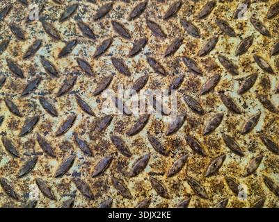 Industrial weathered metal floor with heavy orange rust and raised tread pattern. Shot at Ecseri ut, Budapest, this high-detail steel plate texture is Stock Photo