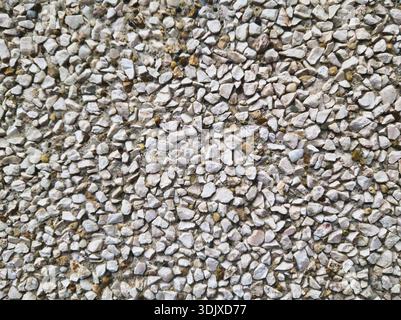 Extreme close up of a washed concrete wall on a socialist era Panelhaz building in Budapest. High resolution texture of multi colored crushed stones a Stock Photo
