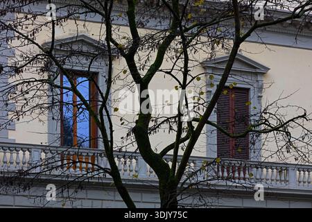 16th century Palazzo Style architecture encompasses  a neighborhood park with trees - Florence, Italy Stock Photo