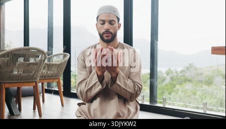 Muslim, man and praying salah in home with faith, praise Allah and spiritual worship in Ramadan. Islamic, male person and prayer with dua, religious Stock Photo