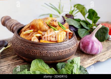 potato vegetable chicken stew. a dish of stewed root vegetables served in a decorative earthenware dish. Stock Photo