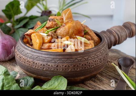 potato vegetable chicken stew. a dish of stewed root vegetables served in a decorative earthenware dish Stock Photo