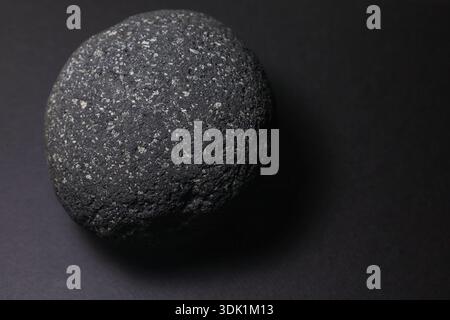 Detailed macro photograph of a volcanic lava stone highlighting rough porous texture, suitable for geology and abstract minimal design use. Stock Photo