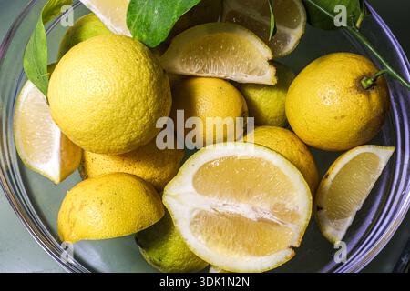 Rustic food-themed composition of citrus fruits in a glass bowl, ideal for nutrition, healthy eating, or culinary visuals. Stock Photo