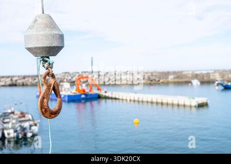 Close up detail of a rusty metal hook from a crane in a fishing port Stock Photo
