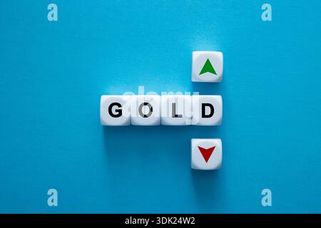 Gold text cubes illustrating market movements with up and down arrows Stock Photo