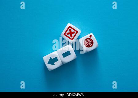 Dices representing direction, error, and target on a blue background Stock Photo