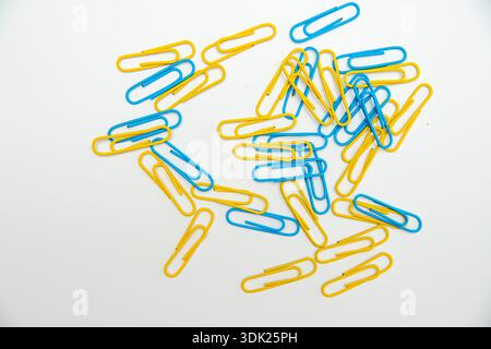 Colorful Paper Clips on White Background, Minimal Office Stationery Concept with Copy Space Stock Photo