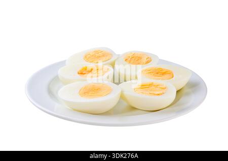 A plate with halved boiled chicken eggs isolated on a white background. Stock Photo