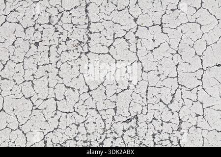White cracked paint distressed background. Grunge peeling paint texture. Stock Photo