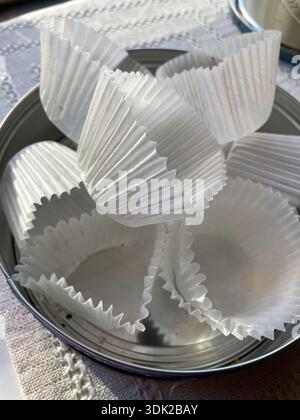 Still life of fluted paper cups in an empty cookie tin, United States Stock Photo