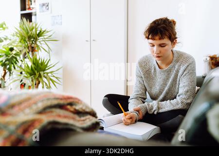 young woman writing notebook Stock Photo