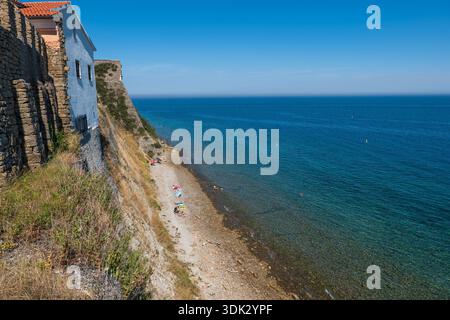 Rocky beach by the Adriatic Sea in town of Piran in Slovenia. Stock Photo