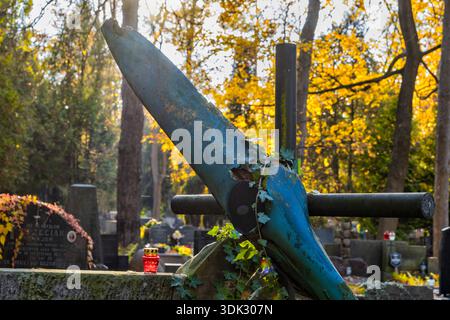 Aircraft propeller fixed to a cross at grave of a pilot at Powazki Military Cemetery in Warsaw, Poland. Stock Photo