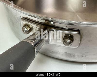 Close up of an empty stainless steel frying pan on white background Stock Photo