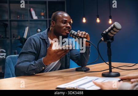 Black man is doing podcast in the studio. Stock Photo