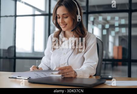 Lot of paperwork. Beautiful woman is in the office. Stock Photo