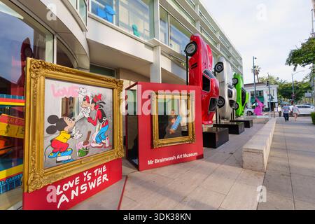 Beverly Hills, California - January 21, 2026: Mr. Brainwash pop art display featuring a graffiti-style Mickey and Minnie Mouse painting with the phras Stock Photo