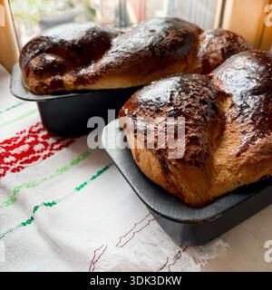 Cozonac, freshly baked Romanian homemade traditional Easter and Christmas sweet bread dessert. Holiday season. Eastern European baked dessert. Stock Photo