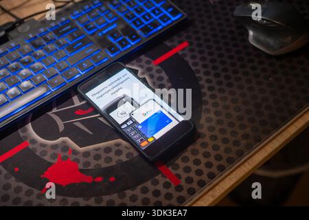 Smartphone screen displaying Google Pay contactless payment interface setup on office desk with keyboard for nfc banking and financial transaction con Stock Photo