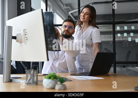 Diagnosis, looking at x-ray. Two doctors are in the office. Stock Photo