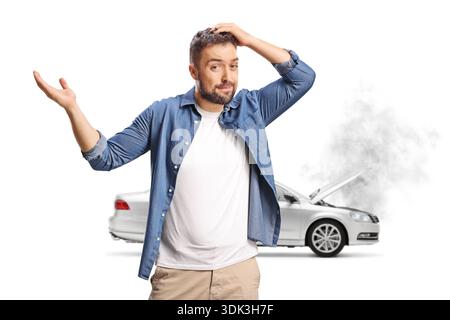 Man frustrated over a broken down car with smoking engine isolated on white background Stock Photo