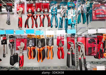Sliema, Malta - January 29, 2026: Various hand tools including pliers, adjustable wrenches, and wire cutters hanging on hooks in a hardware store. Stock Photo
