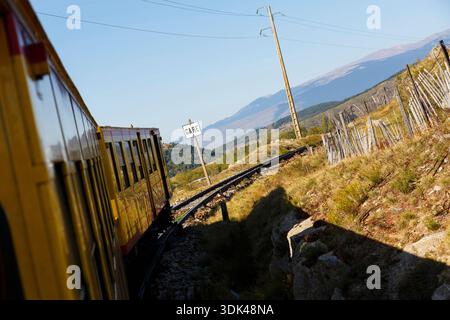 The yellow train 'Le train jaune' on the move, Ligne de Cerdagne, Pyrénées-Orientales, Occitania, France Stock Photo