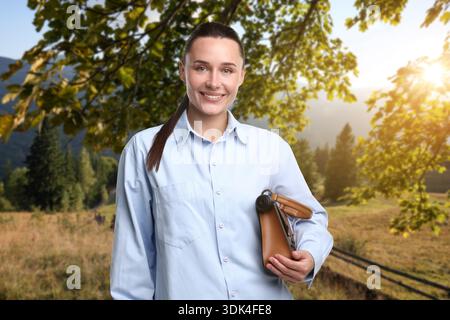 Young woman with hidden spy camera in mountains outdoors Stock Photo