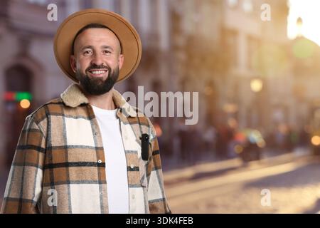 Man with hidden spy camera in his pocket on city street Stock Photo