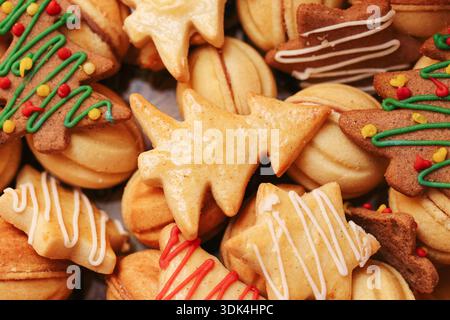 Christmas gingerbread cookies assortment. Homemade holiday baking background. Decorated festive biscuits with icing and spices. Traditional winter. Stock Photo
