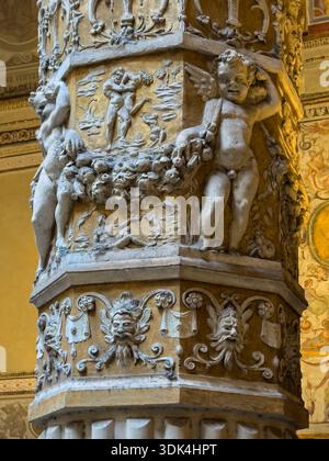 Decorative piller in bas-relief with cherubs in the first courtyard of the Palazzo Vecchio designed by the architect Michelozzo in 1453. -  Florence, Stock Photo