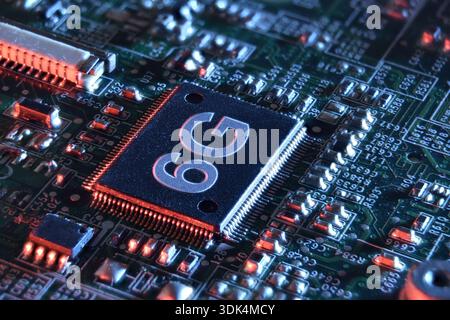 Close-up of a 6G microchip on a circuit board, highlighting advanced semiconductor technology, electronic components, and next-generation wireless con Stock Photo