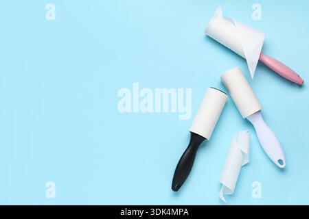 Sticky lint rollers on blue background Stock Photo