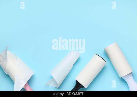 Sticky lint rollers on blue background Stock Photo