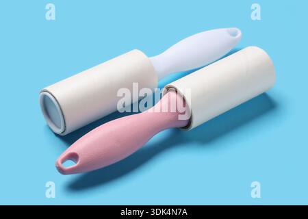 Sticky lint rollers on blue background Stock Photo