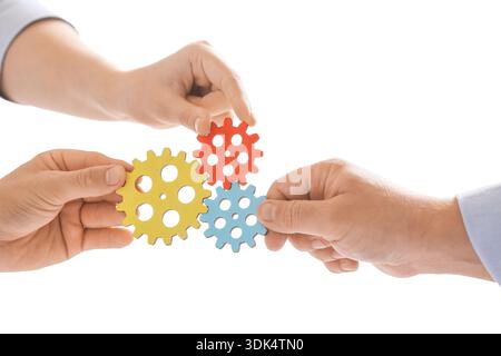 Hands of engineers with gears in office, closeup Stock Photo