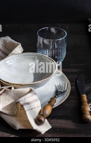 Rustic place setting with bowl and cutlery Stock Photo