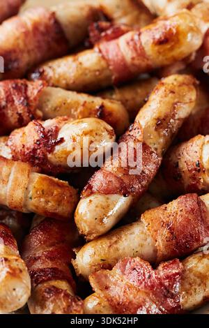 Sausages wrapped in bacon Stock Photo
