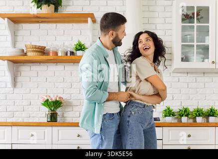 Happy couple dancing in love embracing, cheerful young people enjoy music Stock Photo