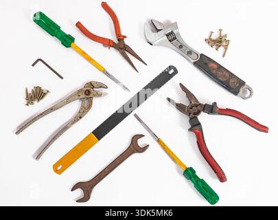 Used hand tools screwdrivers, hacksaw and nippers, pliers. Collection of old used carpenter tools isolated on a white background. Tools series. Variou Stock Photo