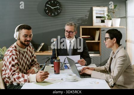 Multiethnic Team Collaborating during Business Meeting in Modern Office Stock Photo