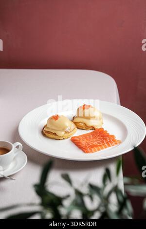 brunch chef assembling eggs benedict with smoked salmon Stock Photo