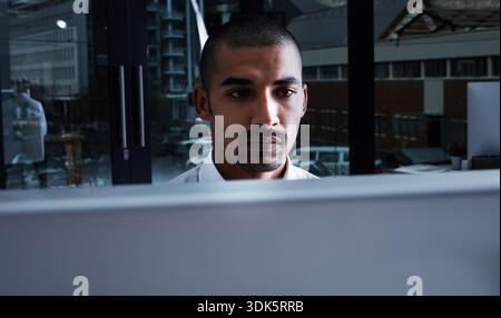 Night, man and software developer in office with computer, AI and cloud computing for cybersecurity. Dark, person and coding in workplace with desktop Stock Photo