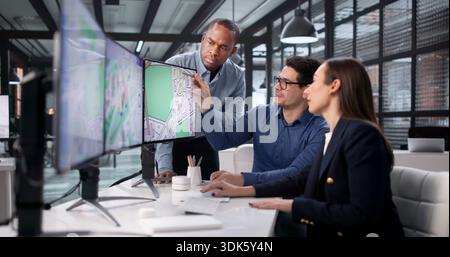 Team Of Diverse Professionals Using GIS To Map Real Estate Projects. Stock Photo