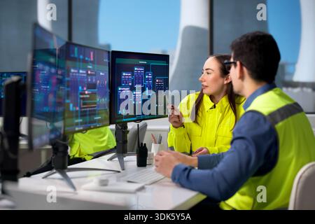 Engineers Monitor Nuclear Power Plant Using SCADA System For Safety. Stock Photo